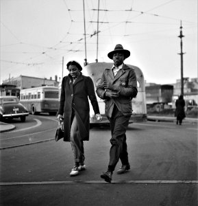 Morning Rush: Workers hurrying to catch a conveyance for work at seven a.m. Baltimore, Maryland, April 1943.