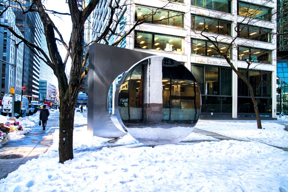 Gateway sculpture with snow and reflection