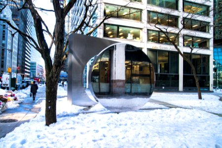 Gateway sculpture with snow and reflection photo
