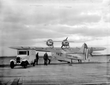 Two kinds of ambulances: the automobile and the airplane ambulances of the Coast Guard at Cape May station stand side-by-side awaiting a call to help injured or sick persons at sea. 1936.
