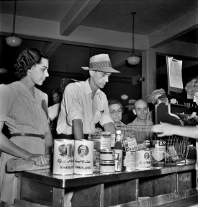 Cashier checking out a customer's purchases at the Will That Be All?: Giant Food shopping center. Washington, D.C. June 1942.