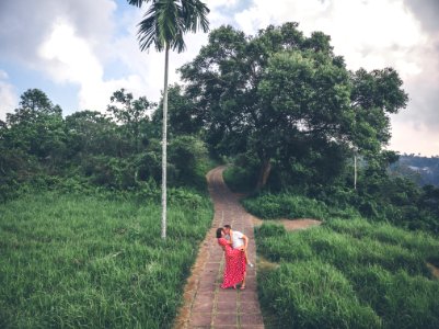 Young couple posing on the road in the jungle of Bali island. photo