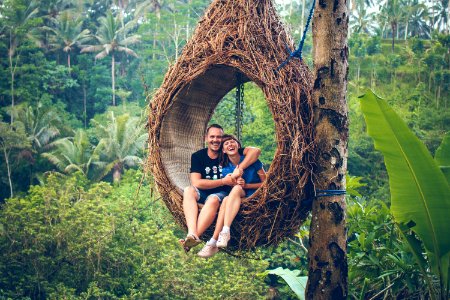 Traveler honeymoon couple in the jungle of Bali island, Indonesia. Couple in the rainforest. photo