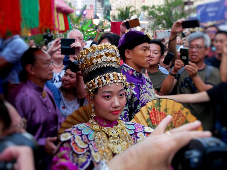 singapore heritage festival - peranakan museum: peranakan wedding where everyone is trying to get a good shot of the couple