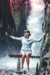 Beautiful woman swings near waterfall in the jungle of Bali island, Indonesia. photo