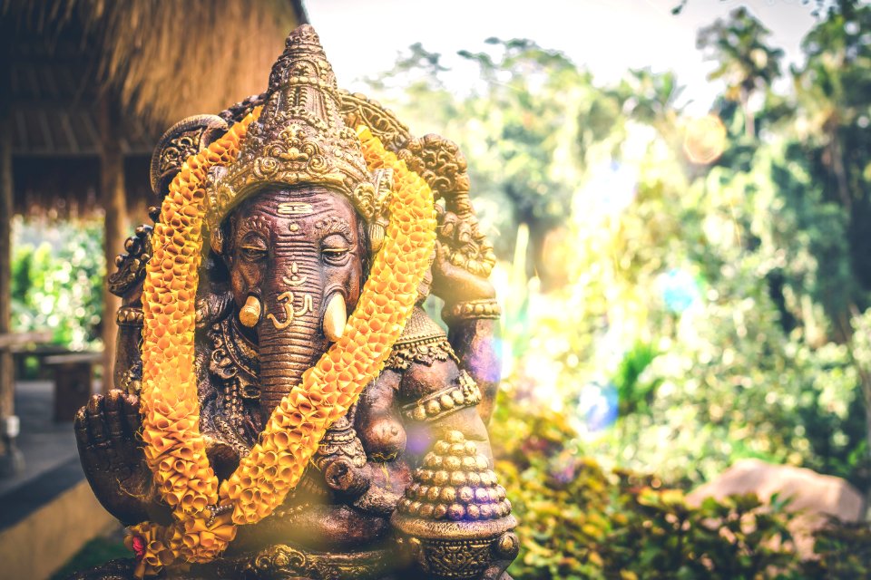 Close up Bronze Ganesha statue and Golden texture. Ganeshs is hindu god of Success. Bali island. photo