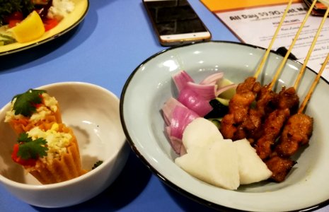 Kueh pie tee and satay. Satay is a local Malay food of skewered grilled marinated meat served with spicey sauce with nuts.