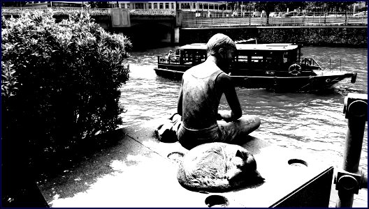 a boy and his dog statues along Singapore River photo