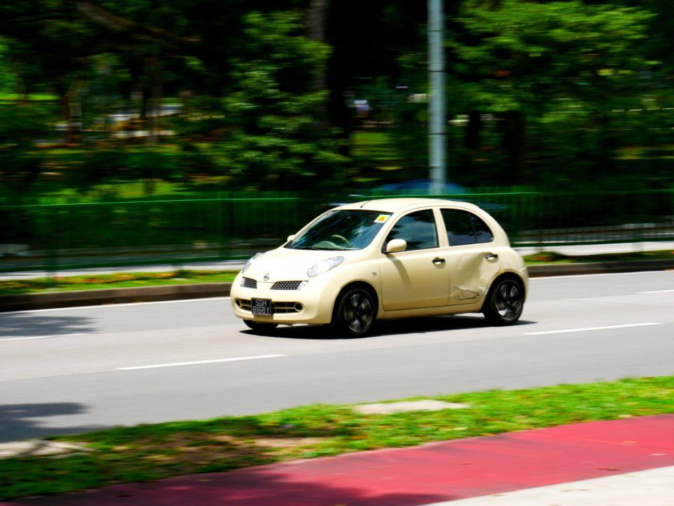 dented small car on the road