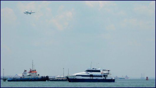 aircraft flying over boats