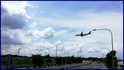 aircraft flying over beach and roads to airport