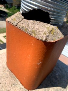 Damaged chimney vent by squirrel photo