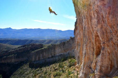 Climber hangs from his rope assessing his last traverse. Homestead Climbing Area, Tucson AZ. Photo by photo