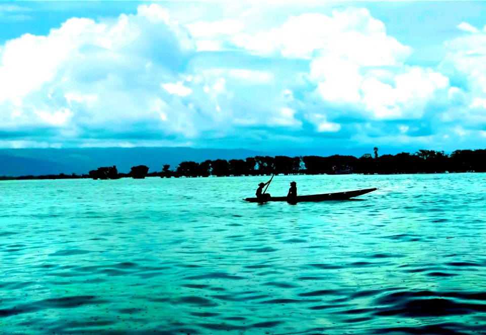 Two Girls Boating on Tanguar Haor in Rain