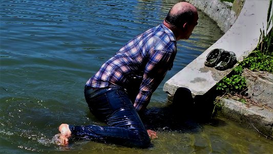 wet guy climbs out of the water