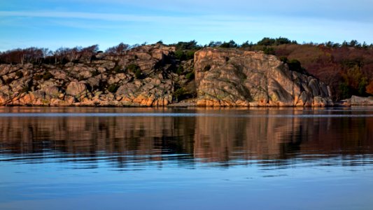 Reflection of the cliffs on Ryxö island in Brofjorden photo