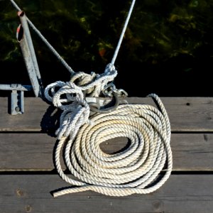 Coiled white rope on a jetty photo