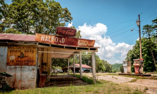 Abandoned Grocery Store with Retro Gas Pumps photo