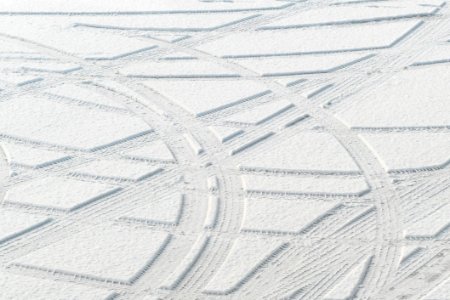 Tire tracks in new snow at a parking lot