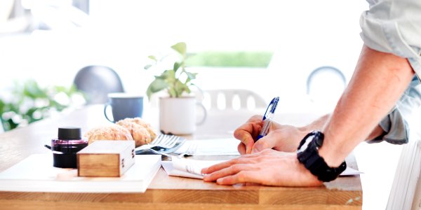Man Writing Document Dinning Table Concept photo
