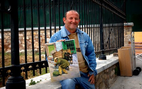 Street artist Romeo with his painting