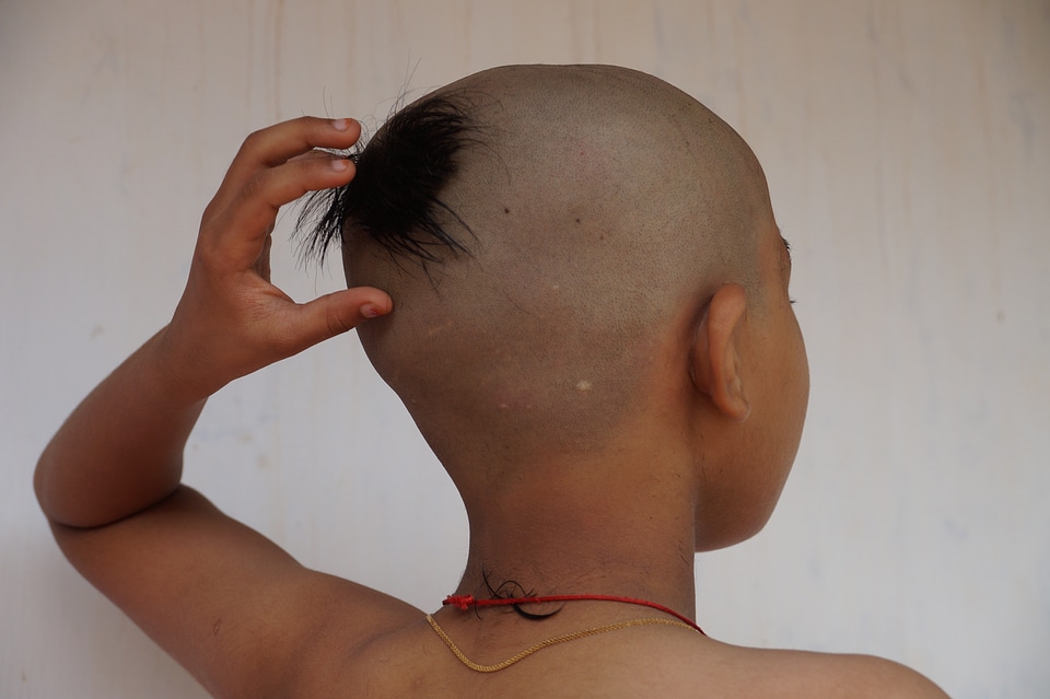 Religious function boy hair cut