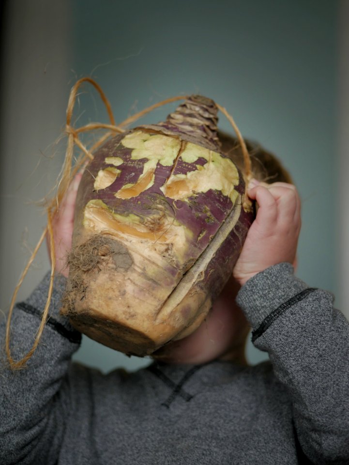 Hop tu Naa turnip lantern being held by a child