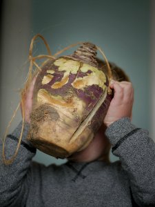 Hop tu Naa turnip lantern being held by a child