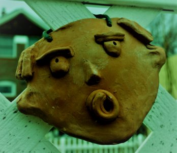 Mask hung on a fence.