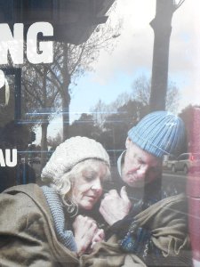 Bus shelter poster and reflections.