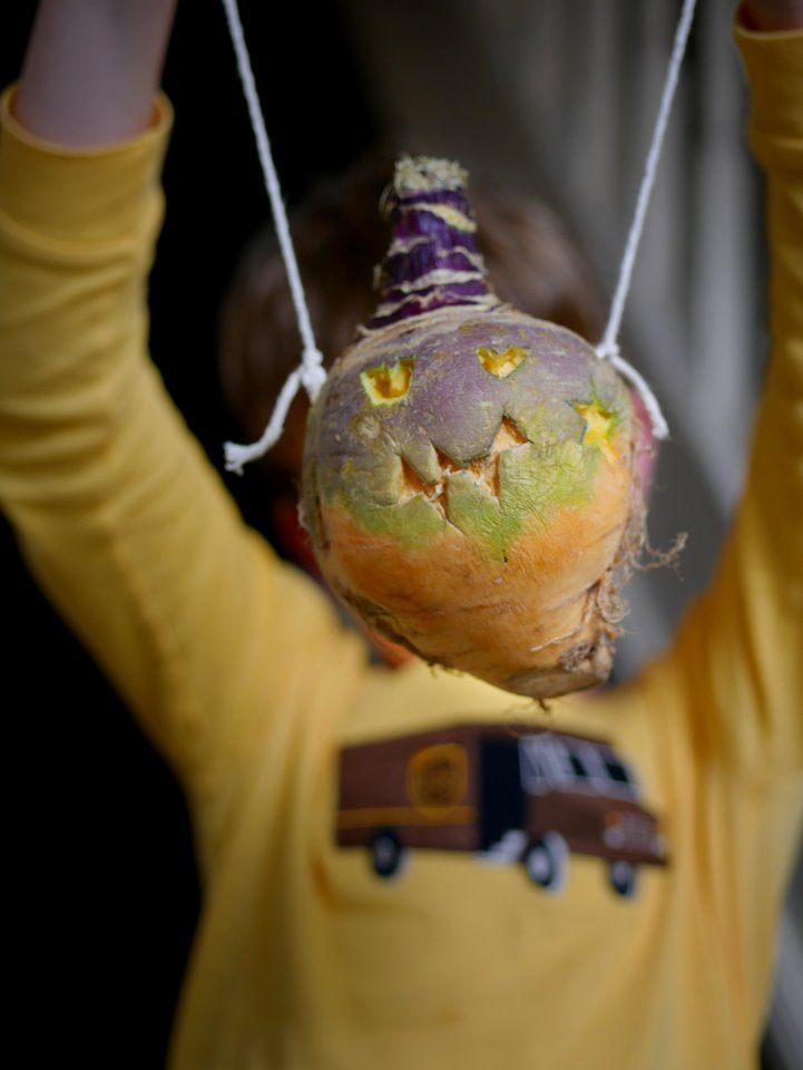 Child holding a Hop tu Naa turnip