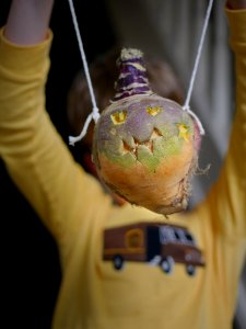 Child holding a Hop tu Naa turnip