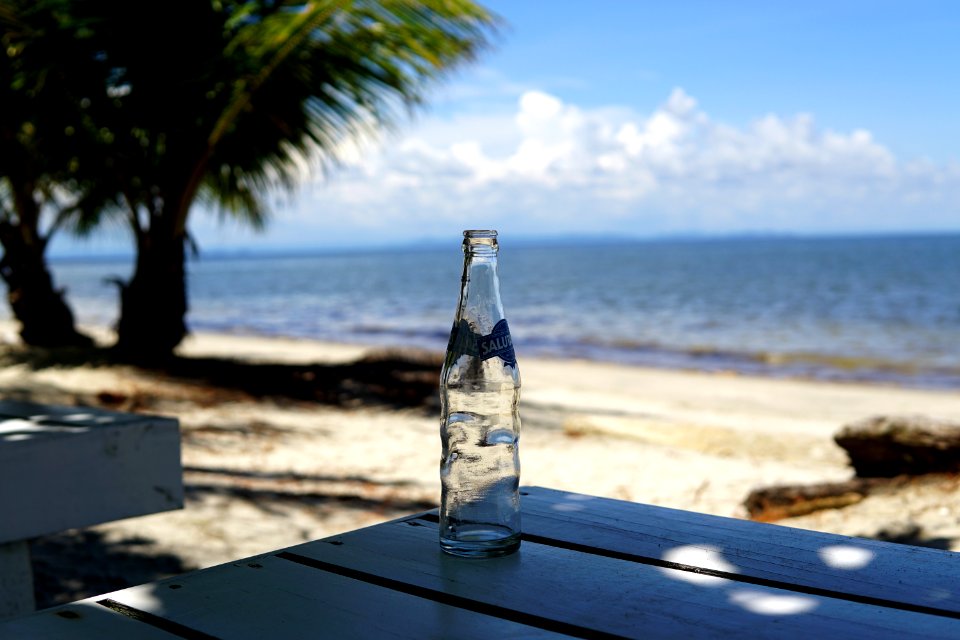 The ocean through an empty glass bottle