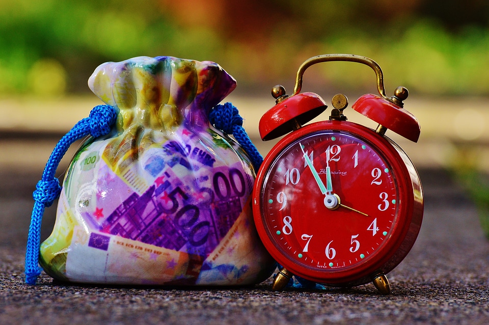 Clock time money bag