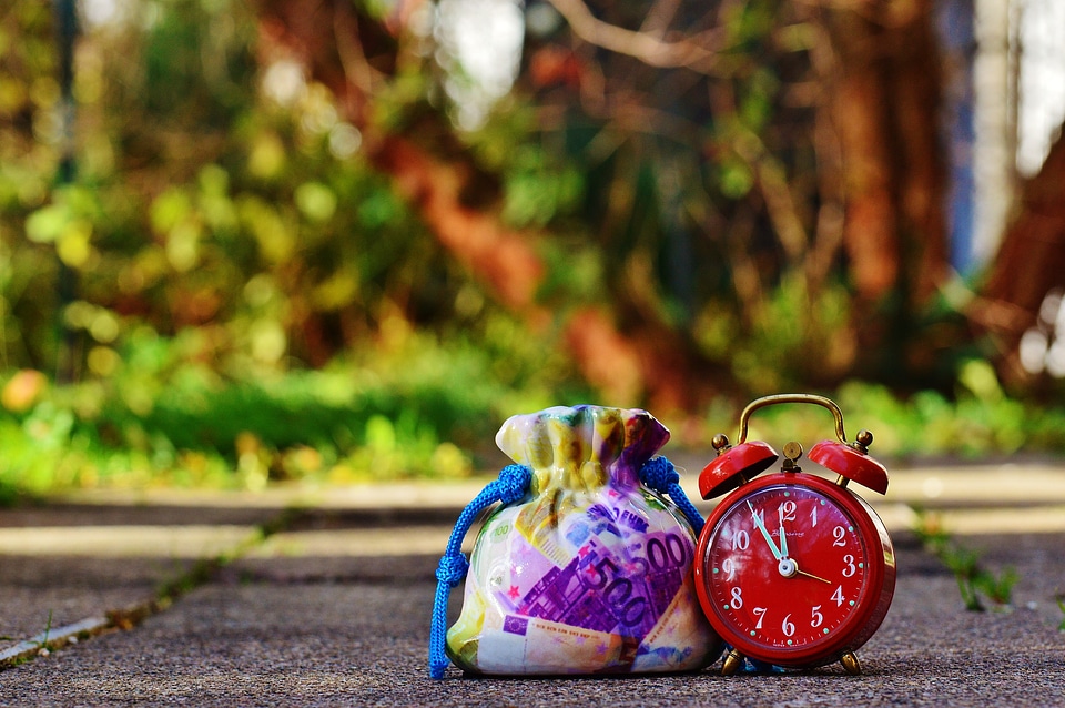 Clock time money bag