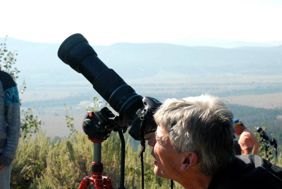 Visitor photographing eclipse from Signal Mountain Summit