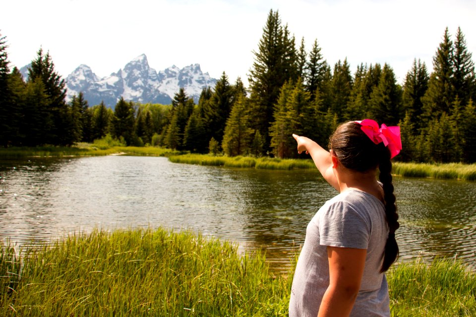 Visitor pointing towards mountains