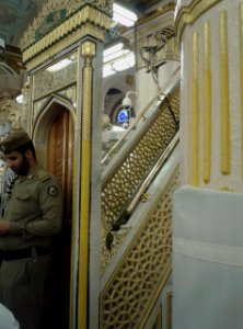 An officer guards the Mimbar door