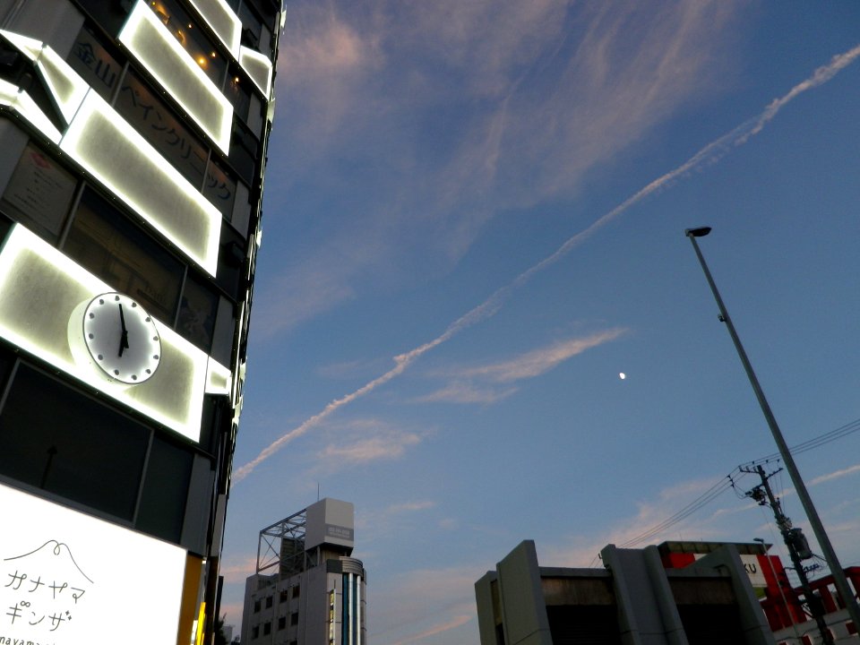 Contrail and Half Moon at 5:55 pm