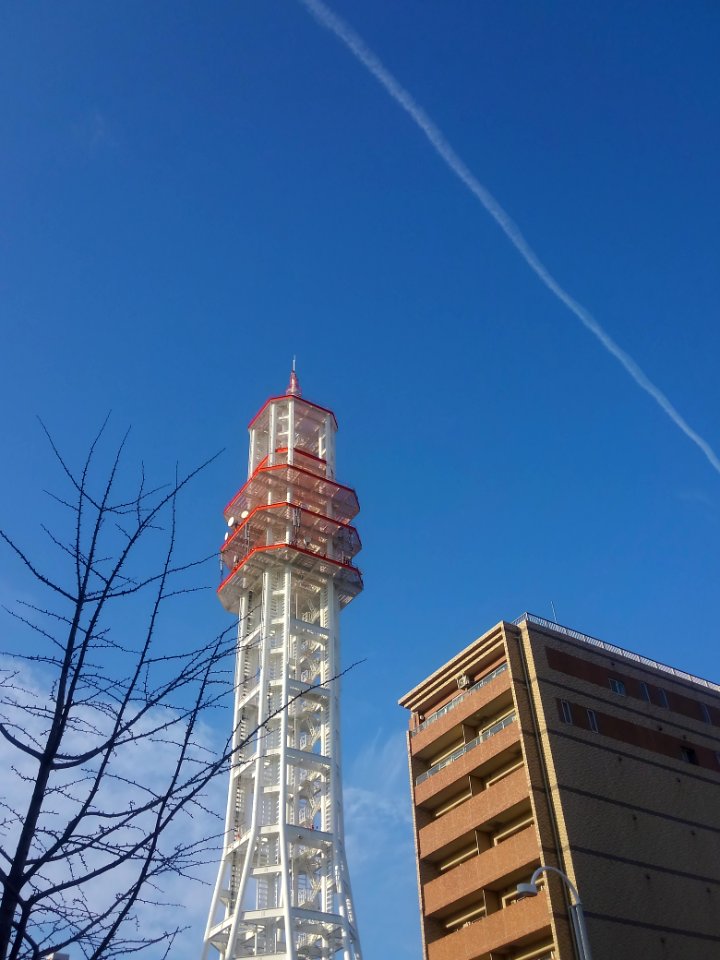 radio tower and contrail