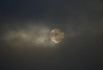 Luna llena semioculta por las nubes photo