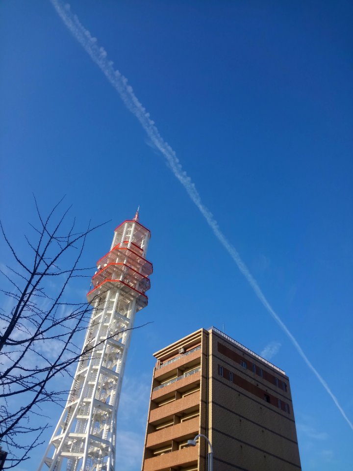 radio tower and contrail