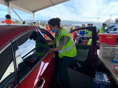 Sara Diggs, a senior firefighter on the Iron Mountain Hand Crew on the Eldorado National Forest in California, runs a vaccination station at the Oakland Coliseum Mass Vaccination Site, Feb 23, 2021. USDA Forest Service photo by Hannah Nadeau.