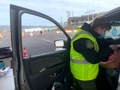 Hannah Nadeau, a U.S. Forest Service law enforcement officer assigned to the Medicine Bow-Routt National Forest and Thunder Basin National Grassland in Wyoming, runs a vaccination station at the Oakland Coliseum Mass Vaccination Site, Feb 23, 2021. USDA F photo