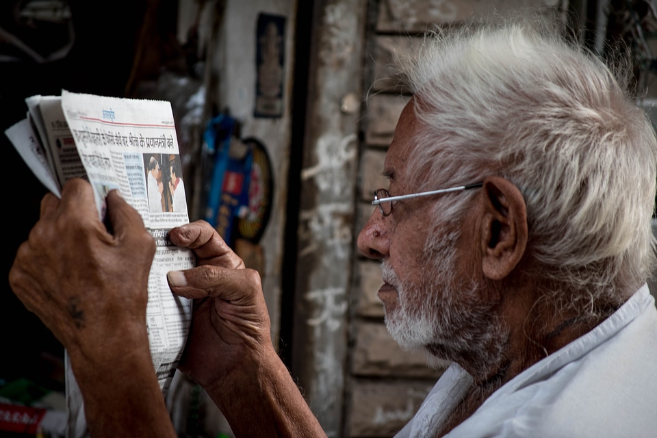 Person reading newspaper education