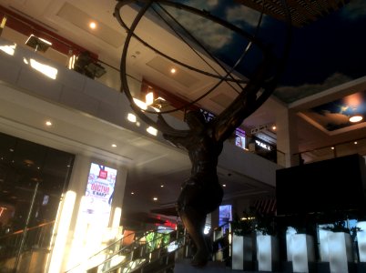 the statue holding up the globe in the shopping center Vegas