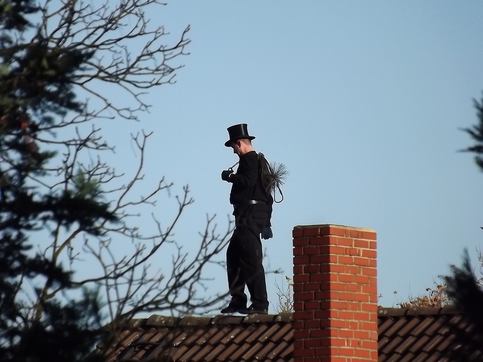 Chimney sweep roof black man