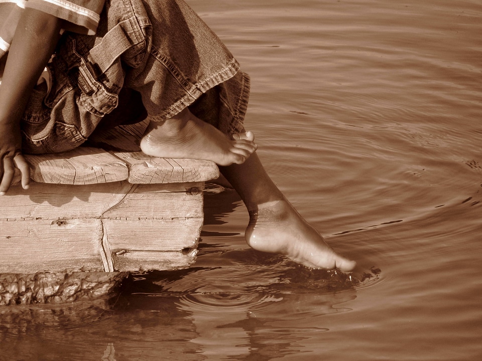 Child boy playing in water