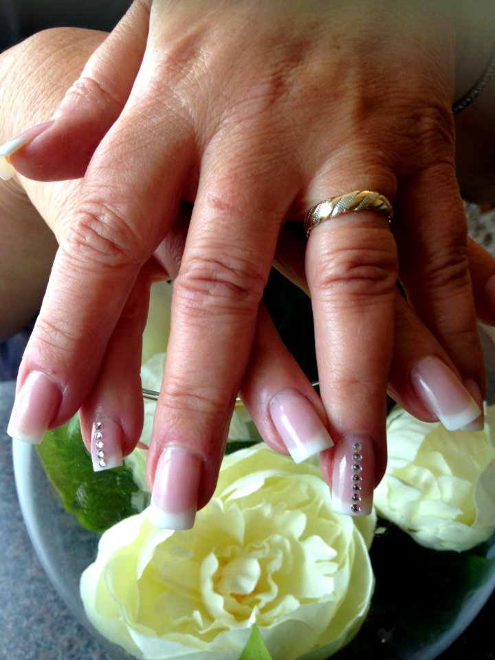 Almond shape nails with peach blush acrylic and bronzed glitter gel on ring fingers.