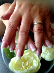 Almond shape nails with peach blush acrylic and bronzed glitter gel on ring fingers.